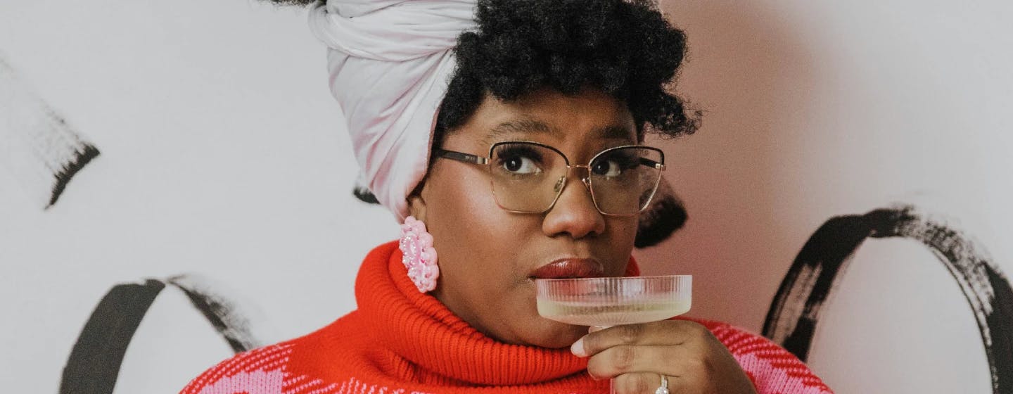 a black woman sipping champagne representing firefish's win at the david ogilvy awards 2022 with Dove