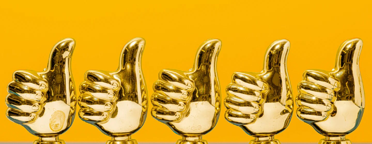 5 thumbs up trophies representing firefish's 5th award win for work on paypal's global brand purpose